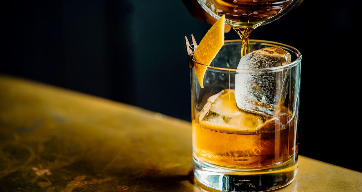 pouring Sazerac cocktail