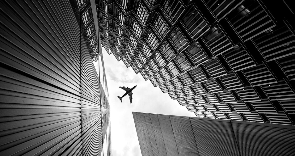 airplane flying over building