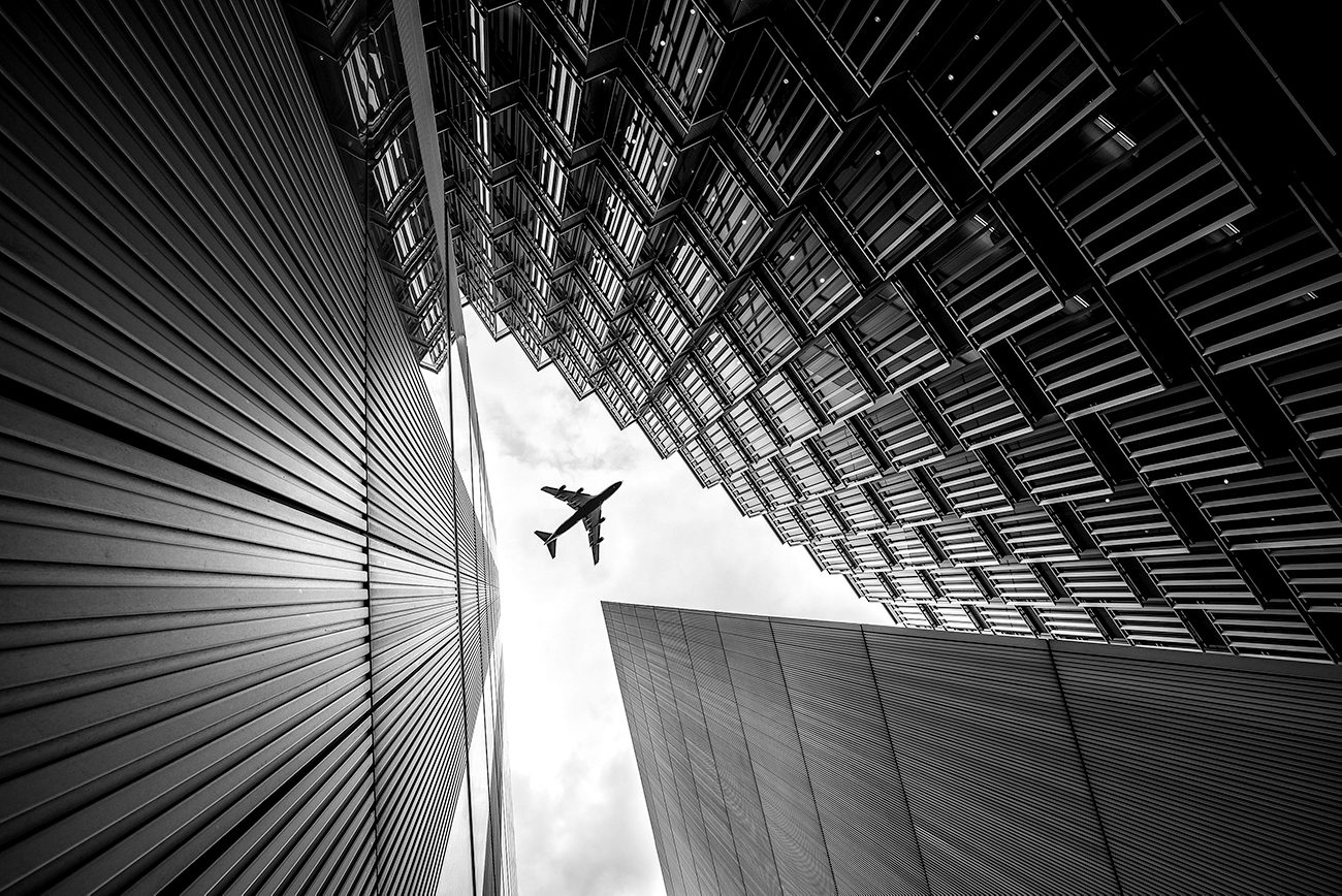 airplane flying over building